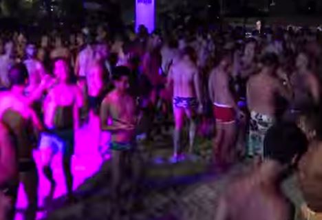 gay Men dancing in gay swim attire at gay parties.