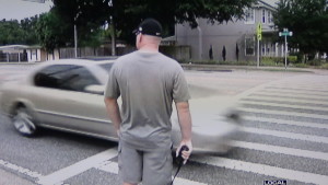 Sgt Richard Ruth radios to a group of cops down the street as cars go by Him that never see Him. Why would someone drive looking to the curb?